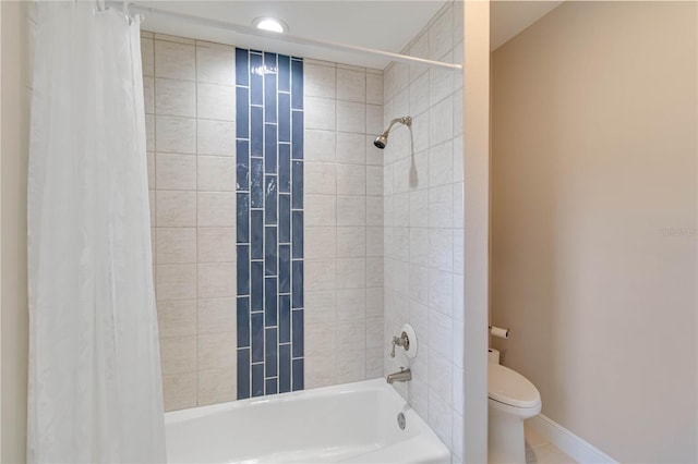 bathroom with shower / tub combo, toilet, and baseboards