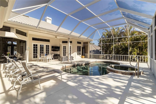 view of pool with a ceiling fan, a patio, glass enclosure, french doors, and a pool with connected hot tub