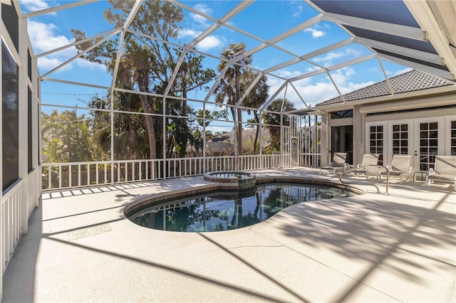 view of swimming pool featuring a lanai, a patio area, a pool with connected hot tub, and french doors