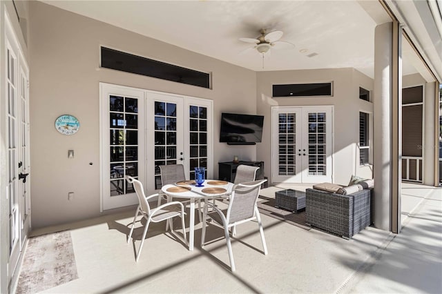 view of patio / terrace with outdoor dining space, ceiling fan, an outdoor living space, and french doors