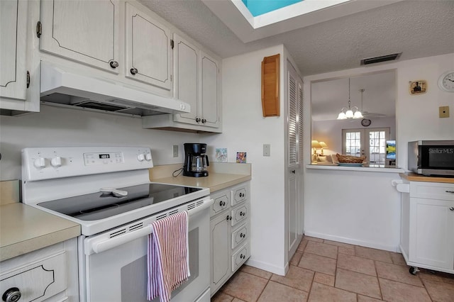 kitchen featuring electric range, light countertops, under cabinet range hood, and white cabinetry