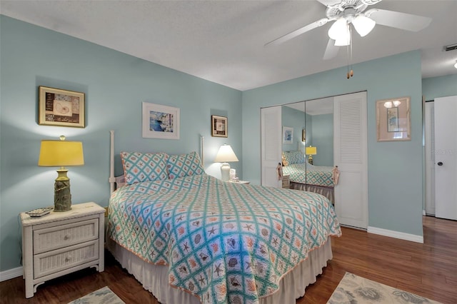 bedroom with ceiling fan, dark wood finished floors, visible vents, and baseboards