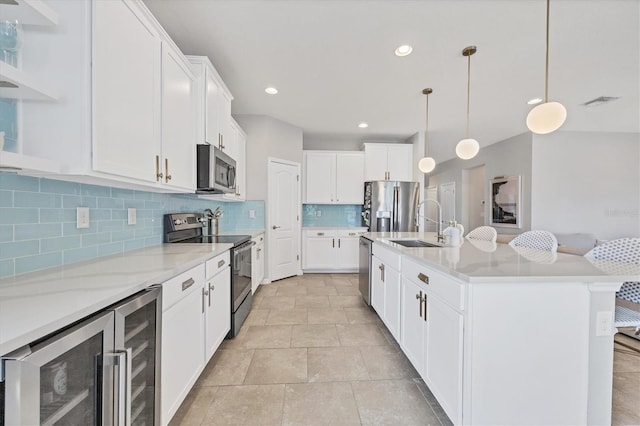 5333 Charlie Brown Ln, Sarasota, FL 34233 - kitchen with appliances with stainless steel finishes, wine cooler, decorative backsplash, white cabinetry, and pendant lighting