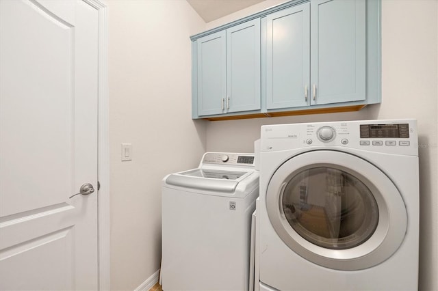 5333 Charlie Brown Ln, Sarasota, FL 34233 - clothes washing area with cabinet space and separate washer and dryer