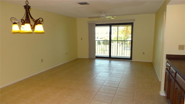 interior space with light tile patterned floors, visible vents, baseboards, and ceiling fan with notable chandelier