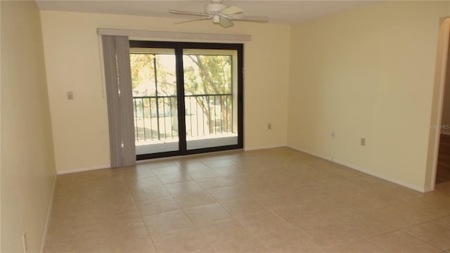 empty room featuring a ceiling fan and baseboards