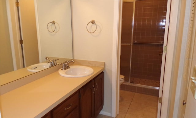 full bathroom featuring tile patterned floors, vanity, toilet, and a shower stall