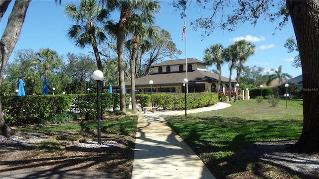 view of property's community with a lawn