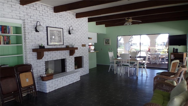 dining space featuring beamed ceiling, a fireplace, and a ceiling fan