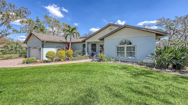 ranch-style house with a front lawn, decorative driveway, an attached garage, and roof mounted solar panels