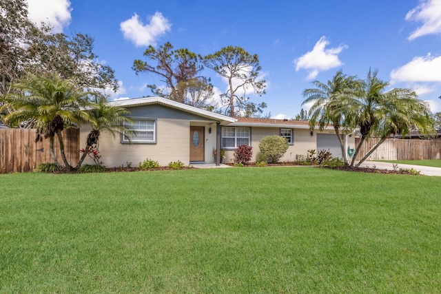 single story home with driveway, a front lawn, an attached garage, and fence