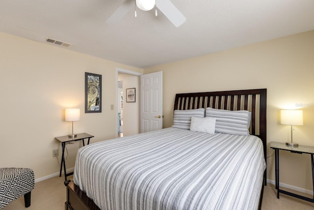 bedroom featuring a ceiling fan, light colored carpet, visible vents, and baseboards