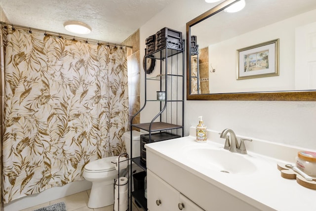 bathroom featuring toilet, tile patterned flooring, a textured ceiling, and vanity