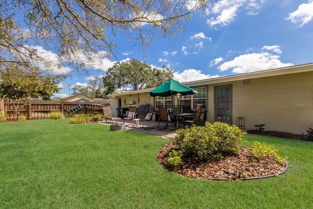 view of yard with a fire pit, a patio, and fence