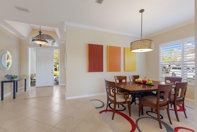 dining room featuring light tile patterned floors, visible vents, baseboards, and crown molding