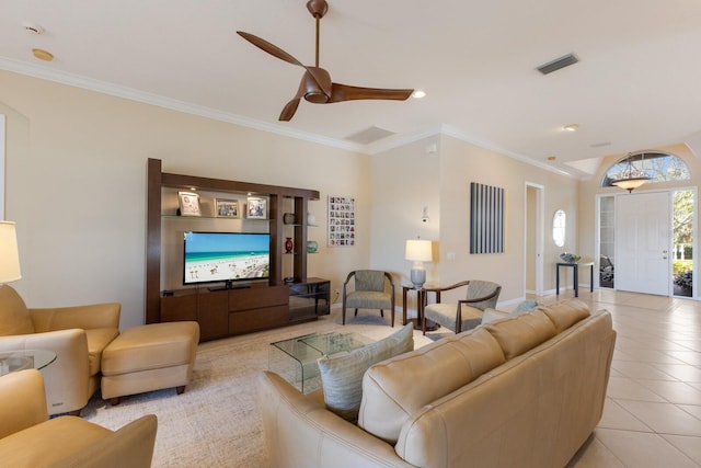 living room with light tile patterned floors, ornamental molding, visible vents, and a ceiling fan