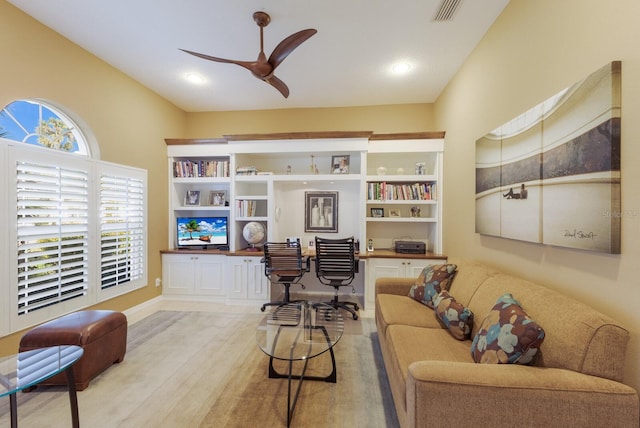 living room with wood finished floors, visible vents, a ceiling fan, vaulted ceiling, and built in study area