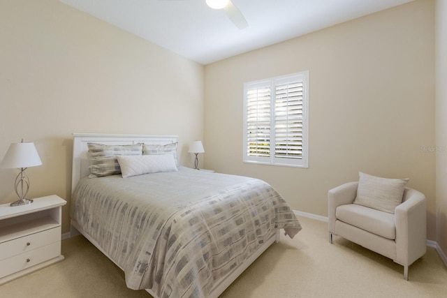 carpeted bedroom with ceiling fan and baseboards