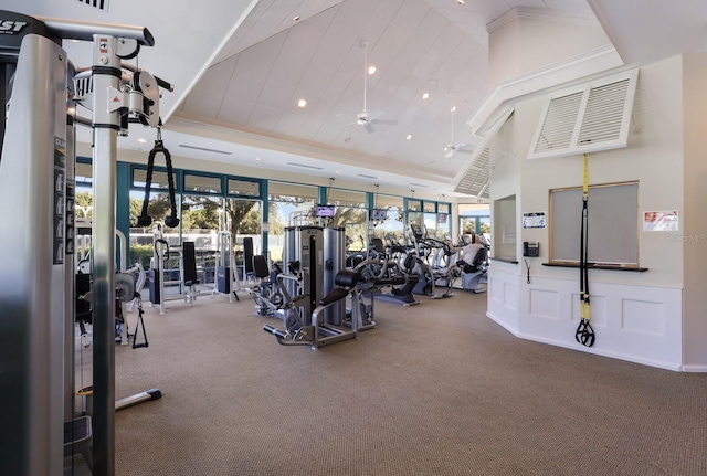 gym featuring a healthy amount of sunlight, a decorative wall, crown molding, and recessed lighting