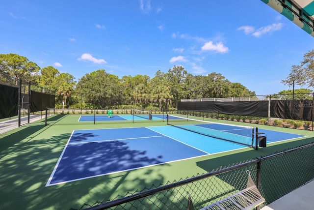 view of sport court featuring fence