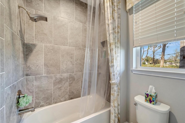 bathroom featuring shower / bath combo and toilet