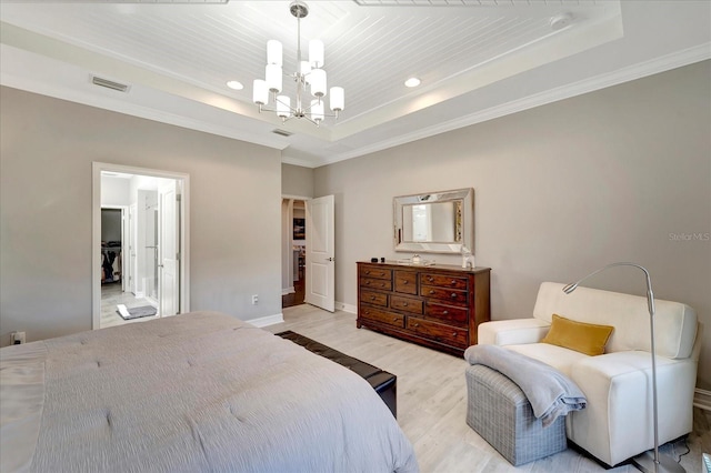 bedroom featuring a raised ceiling, visible vents, light wood finished floors, and an inviting chandelier