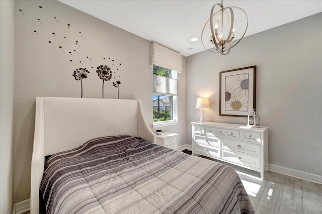 bedroom featuring a chandelier, recessed lighting, light wood-style flooring, and baseboards