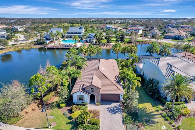 drone / aerial view with a water view and a residential view