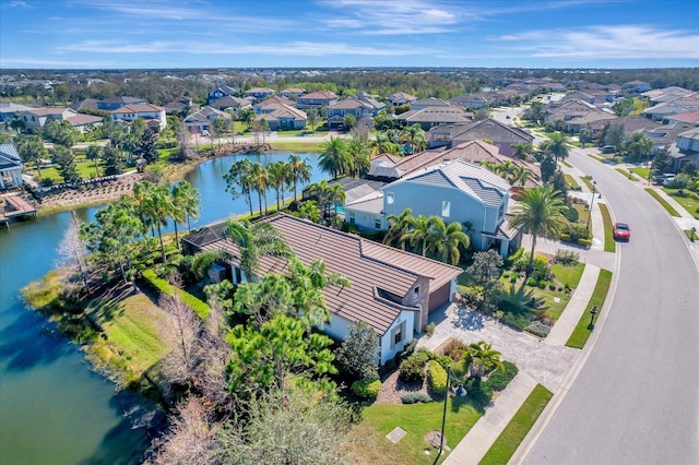 drone / aerial view featuring a water view and a residential view