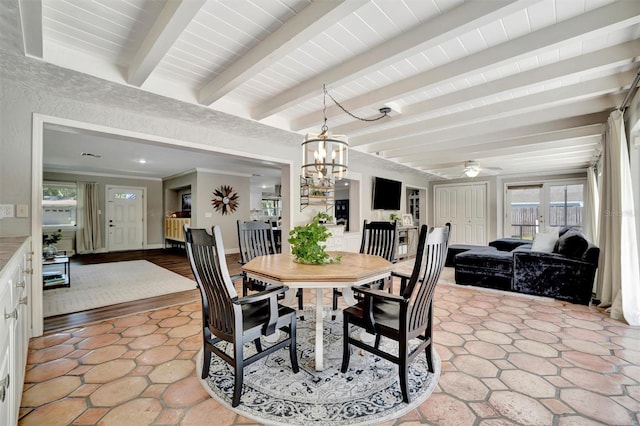 dining room featuring baseboards, beam ceiling, and ceiling fan with notable chandelier