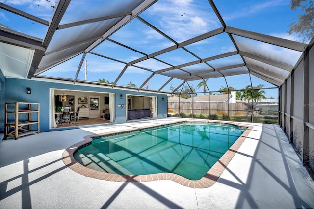 view of swimming pool featuring a lanai, a fenced in pool, and a patio