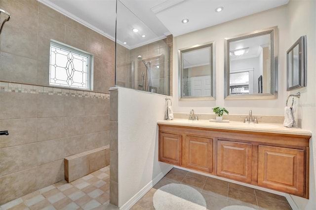 full bath featuring tile patterned flooring, double vanity, a sink, and walk in shower