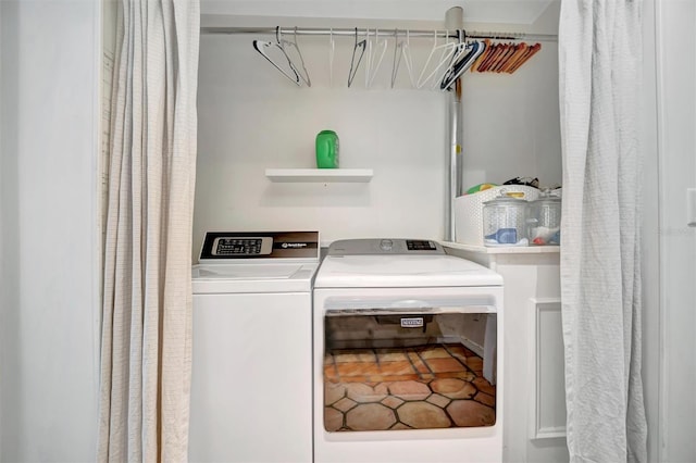 washroom featuring laundry area and separate washer and dryer