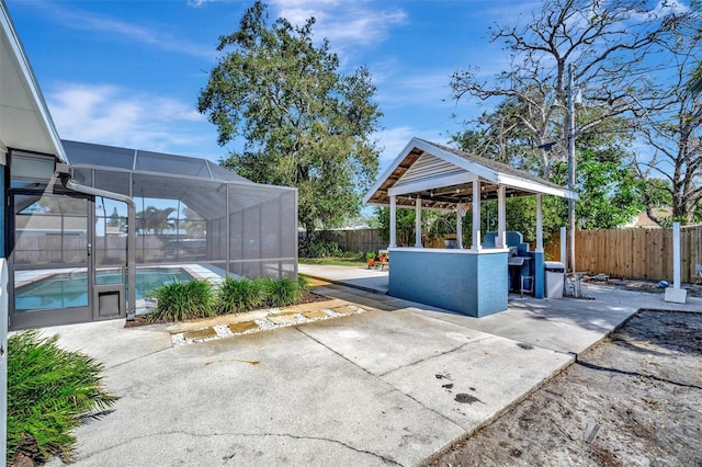 view of patio / terrace with a lanai, a fenced backyard, and a fenced in pool