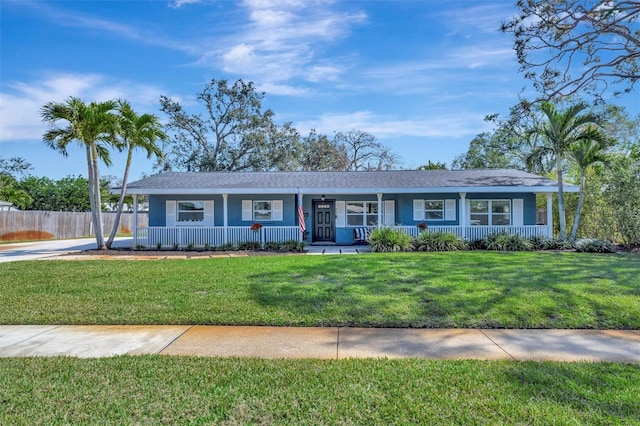 ranch-style house with fence, a porch, and a front yard