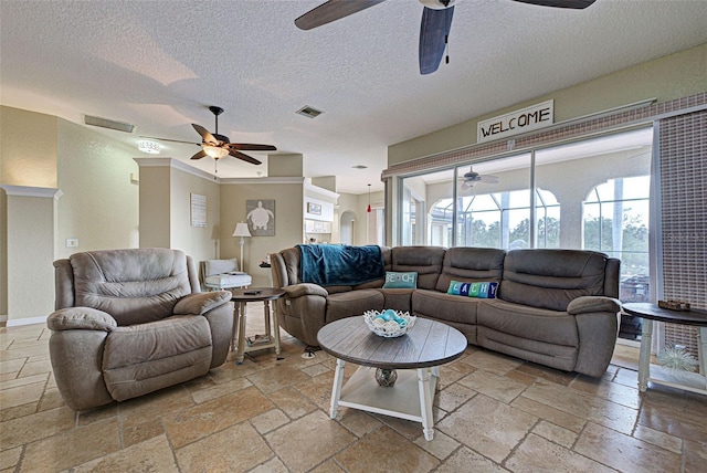 living room with stone tile flooring and visible vents