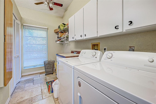 laundry room featuring cabinet space, ceiling fan, stone tile flooring, separate washer and dryer, and a sink