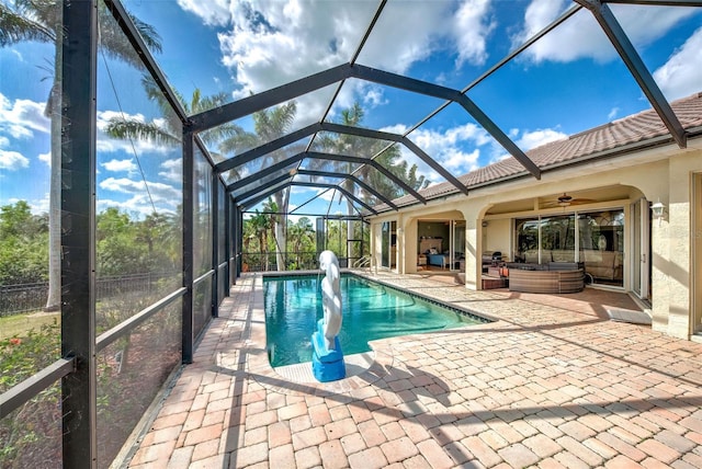 outdoor pool with a patio, outdoor lounge area, a lanai, and a ceiling fan