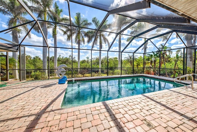 pool with a patio area and glass enclosure