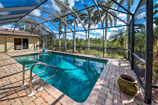 outdoor pool with a patio area and a lanai