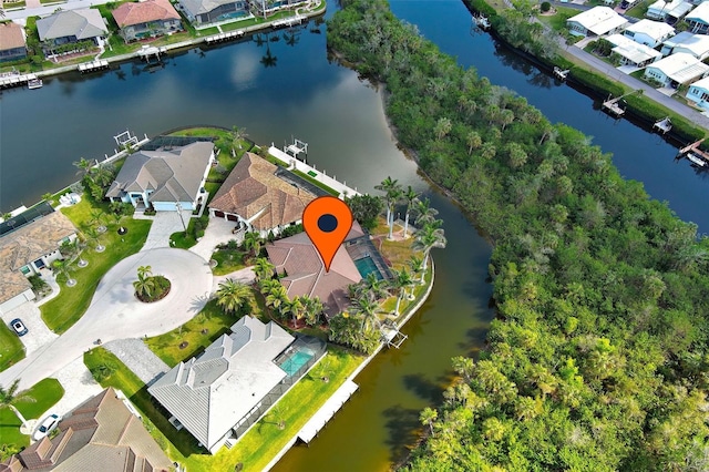 birds eye view of property with a water view and a residential view