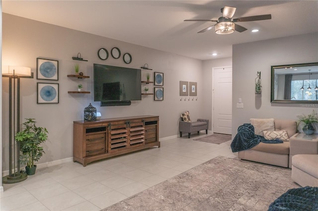 living area featuring ceiling fan, recessed lighting, tile patterned flooring, and baseboards