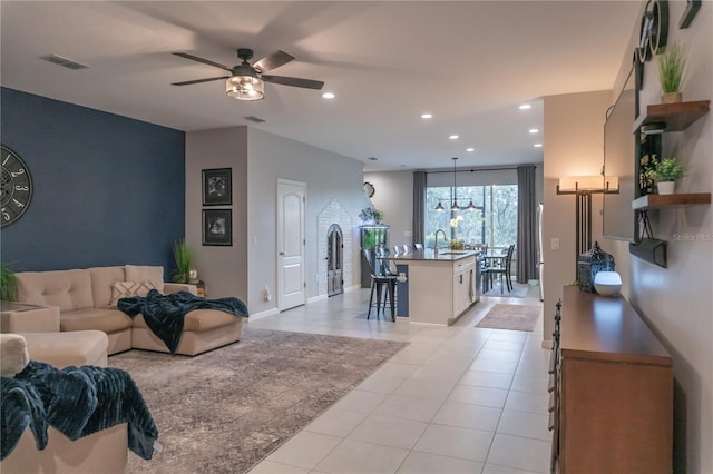 living area with a ceiling fan, light tile patterned flooring, visible vents, and recessed lighting