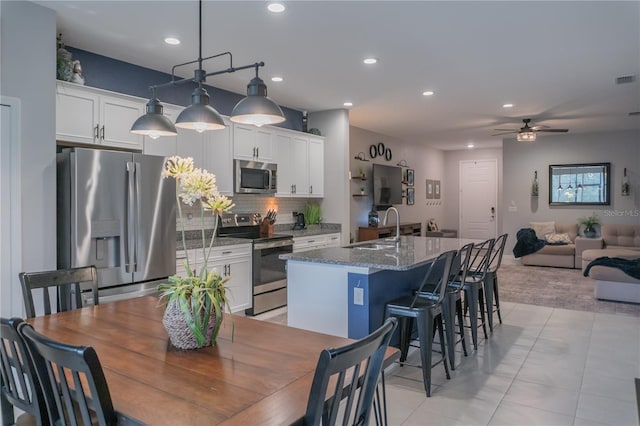 dining area with ceiling fan, light tile patterned flooring, and recessed lighting