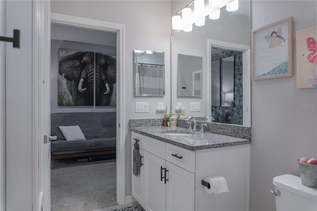 bathroom featuring toilet, ensuite bathroom, and vanity