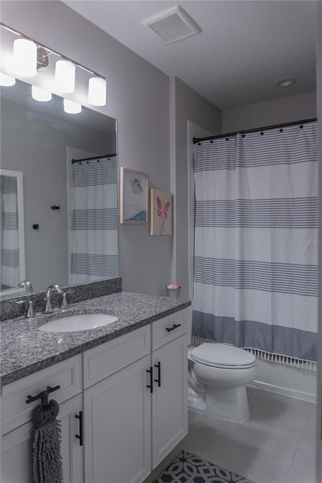 bathroom with a shower with curtain, visible vents, toilet, vanity, and tile patterned flooring