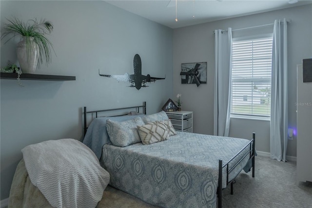 bedroom with carpet floors and baseboards