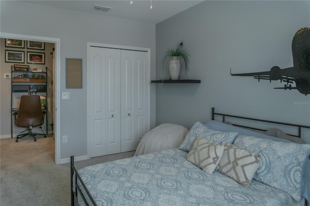 carpeted bedroom with a closet, visible vents, and baseboards