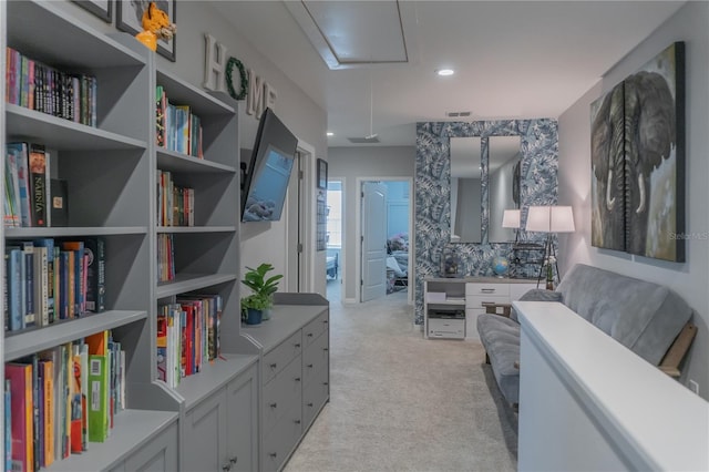 interior space featuring attic access, recessed lighting, light colored carpet, and visible vents