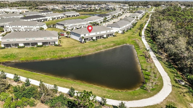 drone / aerial view featuring a residential view and a water view